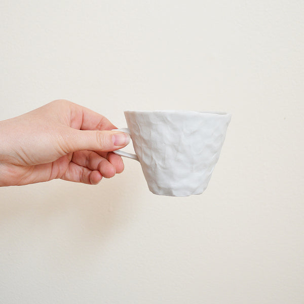 Hand pinched porcelain teacup by Maine potter Ingrid Bathe. Available in Boston shop.