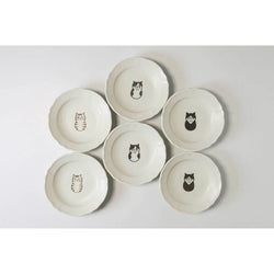 Set of six ceramic plates with cat illustrations on a light gray background