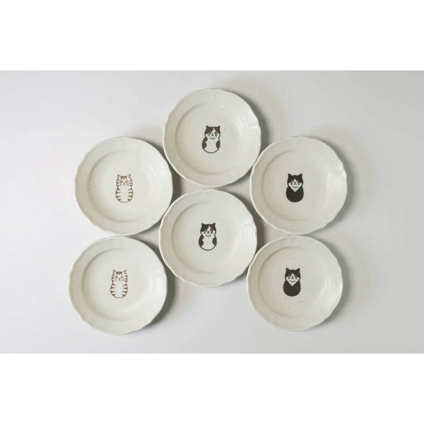 Set of six ceramic plates with cat illustrations on a light gray background