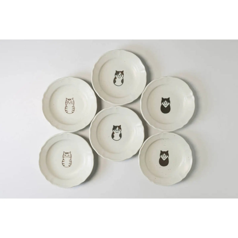Set of six ceramic plates with cat illustrations on a light gray background