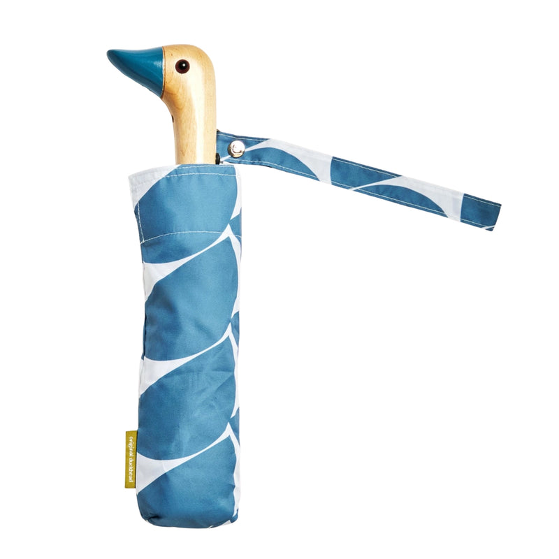 Umbrella with blue half circle pattern with duck head handle against a matching background