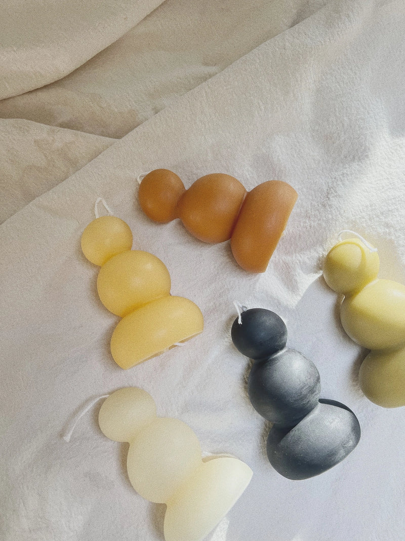 Set of colorful candles on a light fabric background