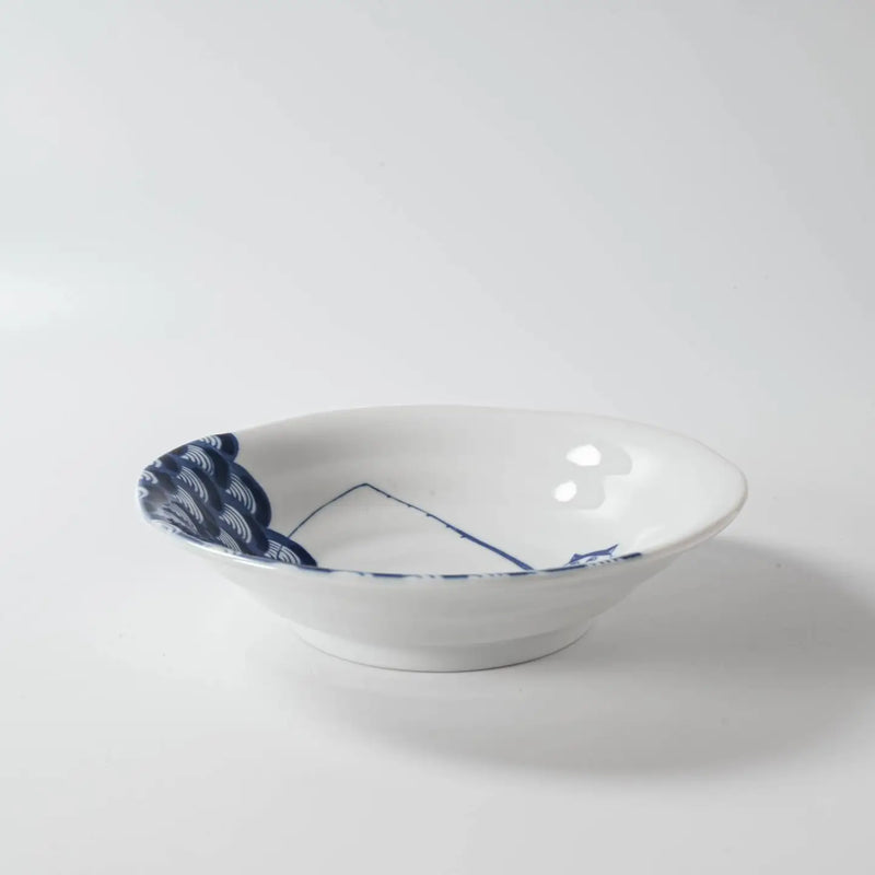 White ceramic bowl with blue floral patterns on a white background