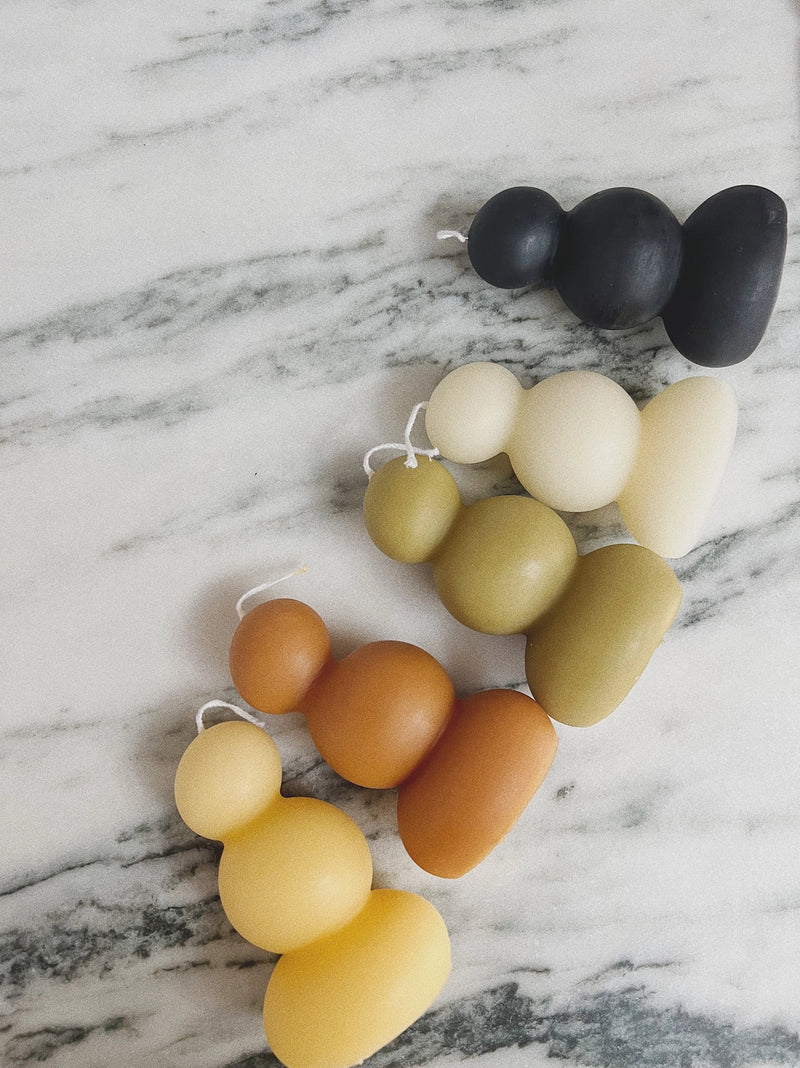 Colorful stacked circle candles on a marble surface