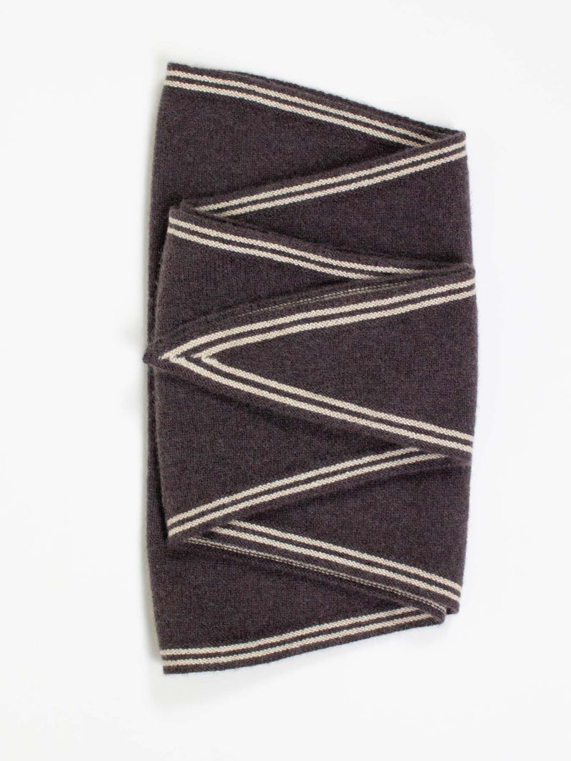 Folded brown scarf with beige stripes on a white background