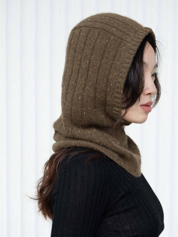 Person wearing an olive green/brown knitted hood against a white background