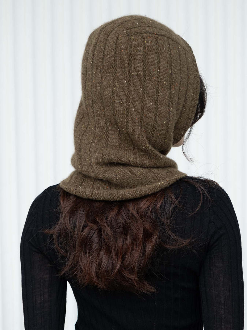 Person wearing an olive green/brown knitted hood against a white background