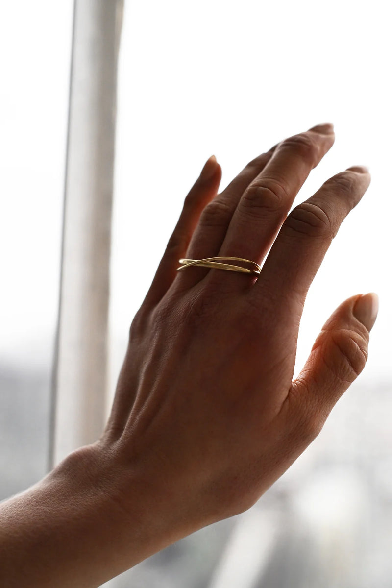 Brass ring on a person's finger with a blurred background