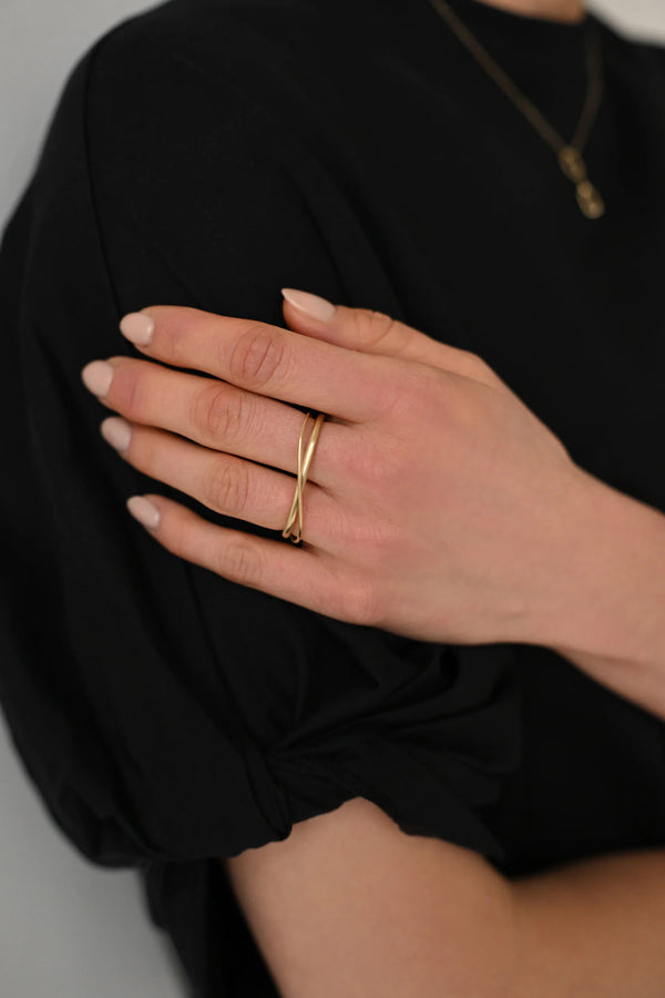 Brass ring on a person's finger with a blurred background