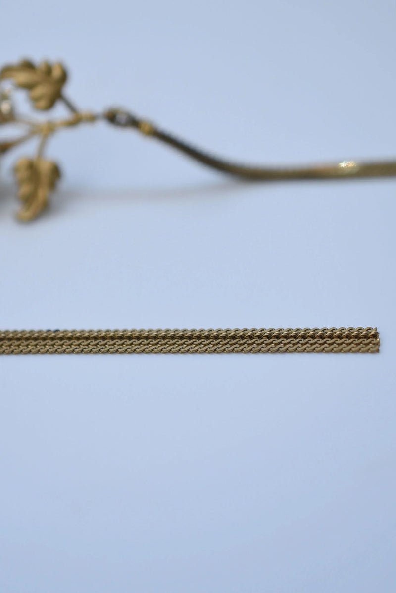 Gold chain on a light blue background