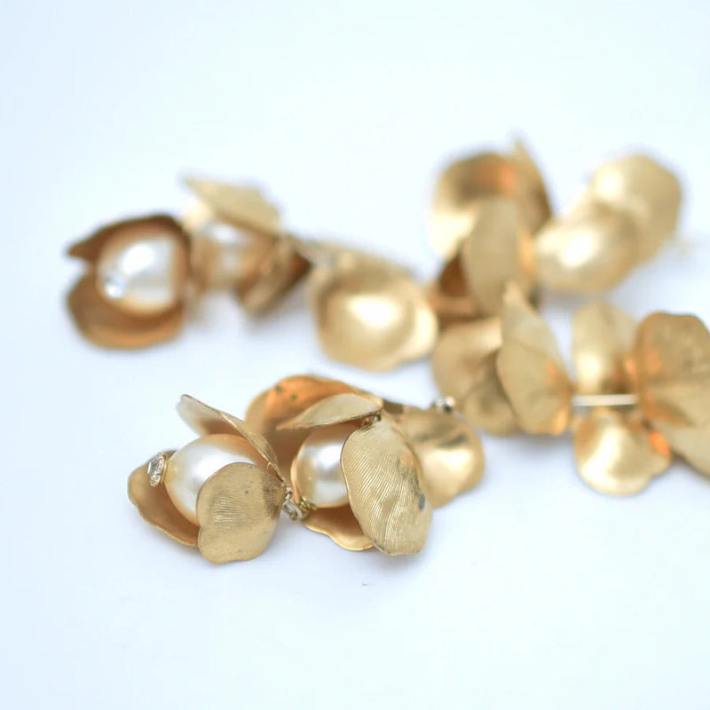 Long chandelier earrings with hanging brass petals and pearl accents 