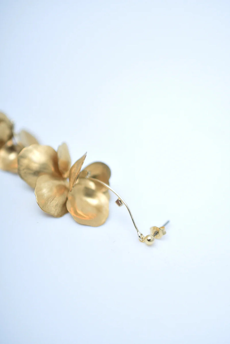 Long chandelier earrings with hanging brass petals and pearl accents 