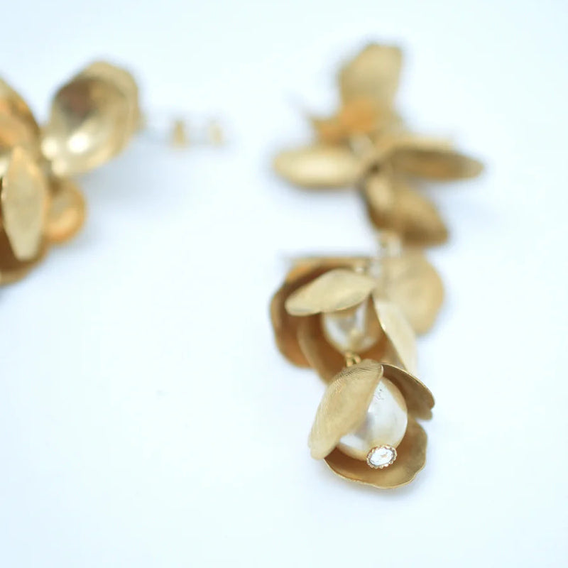 Long chandelier earrings with hanging brass petals and pearl accents 