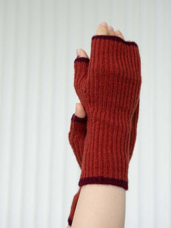 Red knitted fingerless gloves on a white background