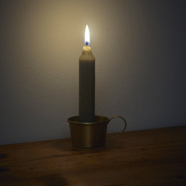 Gray candle in a brass holder on a wooden surface with a dark background.

Fog Linen brass candle holder home decor holiday housewarming shop boston SOWA gift shop gift store boutique
