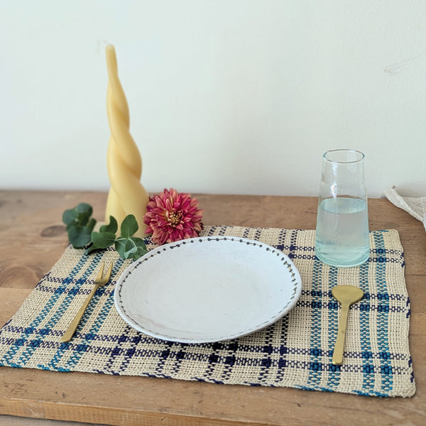 Dining table setting with a plate, glass, and utensils on a checkered placemat.

Guanabana placemats set kitchen dining handmade woven Colombia gift shop Boston boutique gift sowa