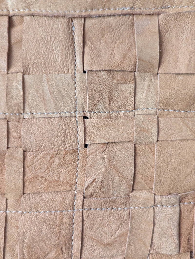 Close-up of woven leather with visible stitching.

Stitch and Tickle Woven Horizonal Shoulder Baguette Tote Bag one of a kind unique leather shop boston New England handmade sowa gift store 