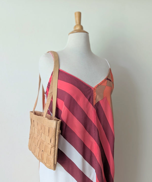 Mannequin wearing a red and white striped dress with a woven beige handbag.

Stitch and Tickle Woven Horizonal Shoulder Baguette Tote Bag one of a kind unique leather shop boston New England handmade sowa gift store 