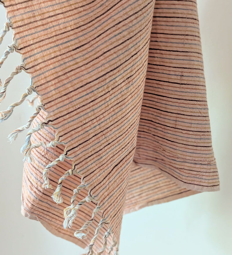 Textured fabric with fringes on a light background. Auntie Oti hand woven khadi cotton kitchen towel natural dye handmade shop Boston sowa gift store boutique
