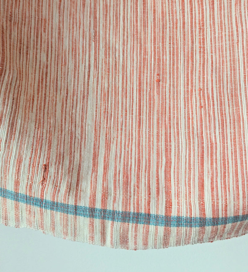 Striped fabric with red and green blue lines on a light blue background. Auntie Oti hand woven space dye khadi cotton kitchen hand towel tablecloth beach blanket sowa shop Boston boutique handmade