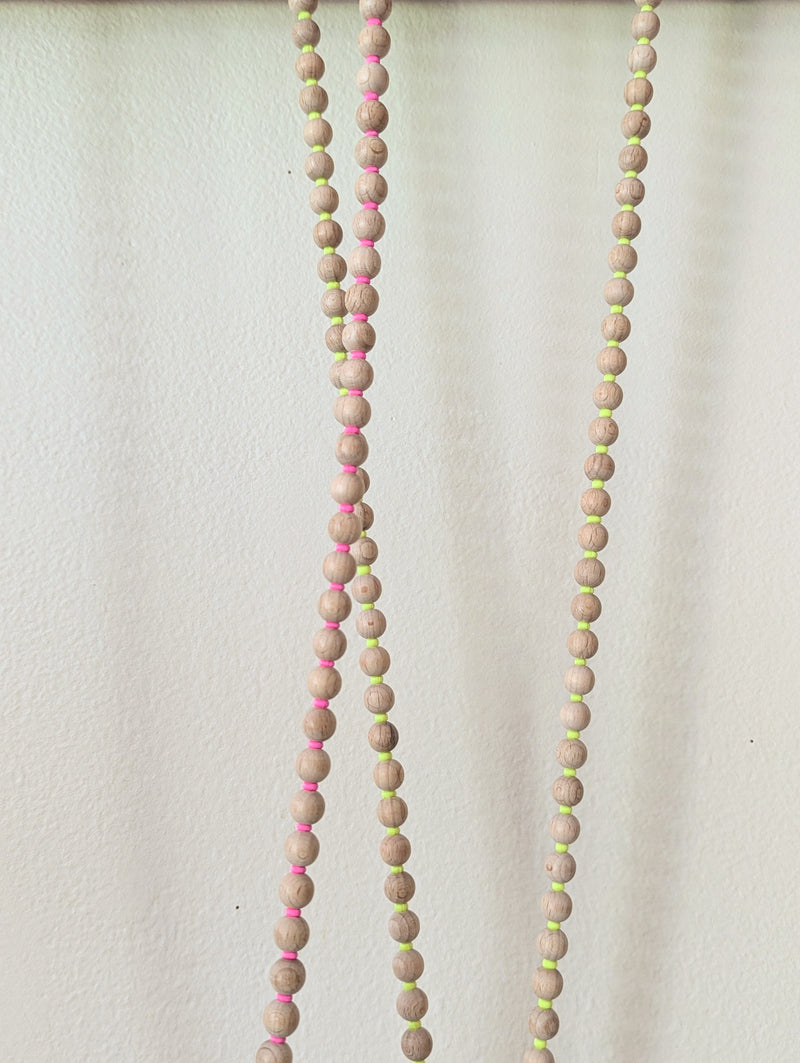 Two stringed bead necklaces with wooden beads and colorful accents on a white background, Ina Seifart Handikette Phone Necklace handmade wood beads gift shop sowa boston fashion accessories independent boutique lanyard keychain