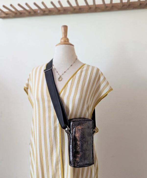 Mannequin wearing a striped dress with a black metallic crossbody bag against a plain background.

Stitch and Tickle unisex messenger travel bag adjustable strap shoulder crossbody leatherwork handmade sowa shop Boston gift shop store