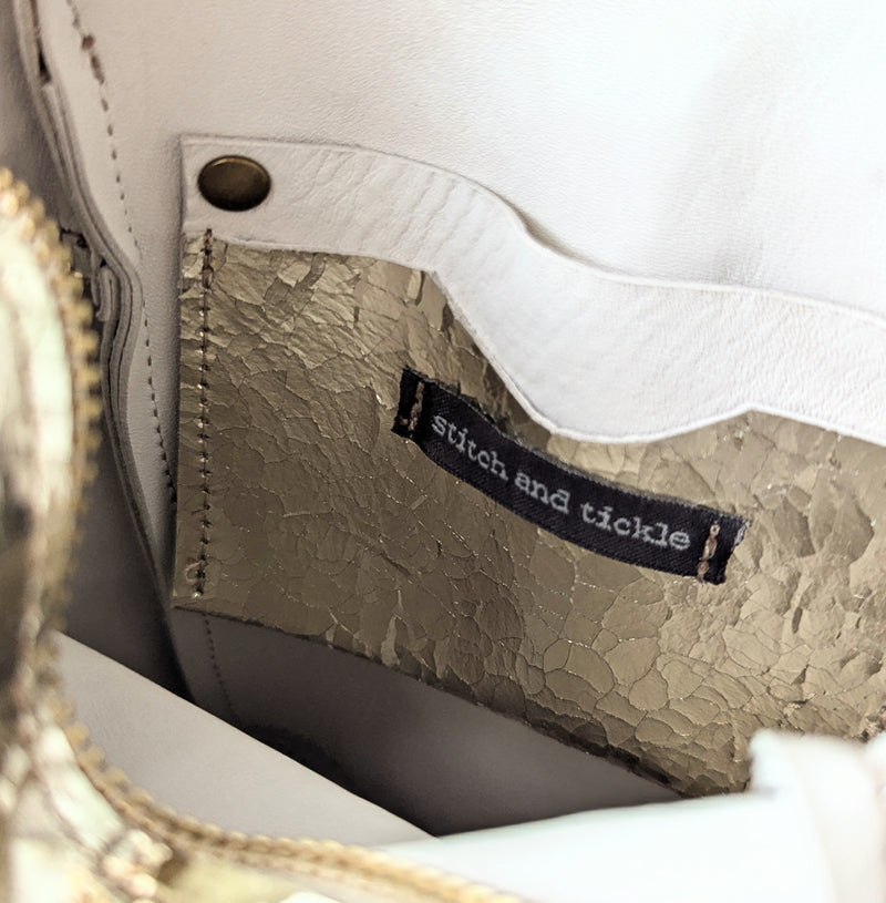 Close-up of an inside of a bag featuring a Cardholder interior pocket

Stitch and Tickle unisex messenger travel bag adjustable strap shoulder crossbody leatherwork handmade sowa shop Boston gift shop store