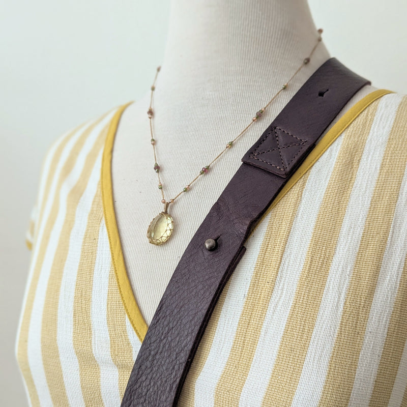 Mannequin wearing a yellow and white striped dress with a brown leather bag strap and necklace.

Stitch and Tickle everyday carryall leather tote shoulder laptop crossbody work bag handmade boston gift shop sowa independent boutique