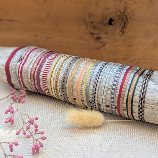Colorful woven bracelets on a wooden surface with flowers in the background

Guanabana woven bracelet handmade jewelry store sowa boston gift shop small business boutique small gifts for her unisex