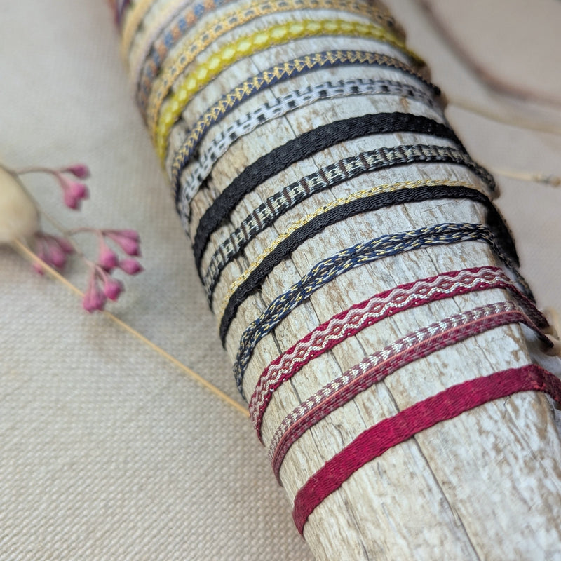 Collection of colorful bracelets on a wooden stick with a neutral background

Guanabana woven bracelet jewelry store sowa boston gift shop small business boutique small gifts for her 