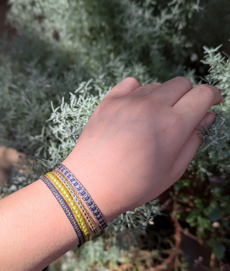 Hand wearing a colorful bracelet with a blurred natural background

Guanabana woven bracelet handmade jewelry store sowa boston gift shop small business boutique small gifts for her unisex