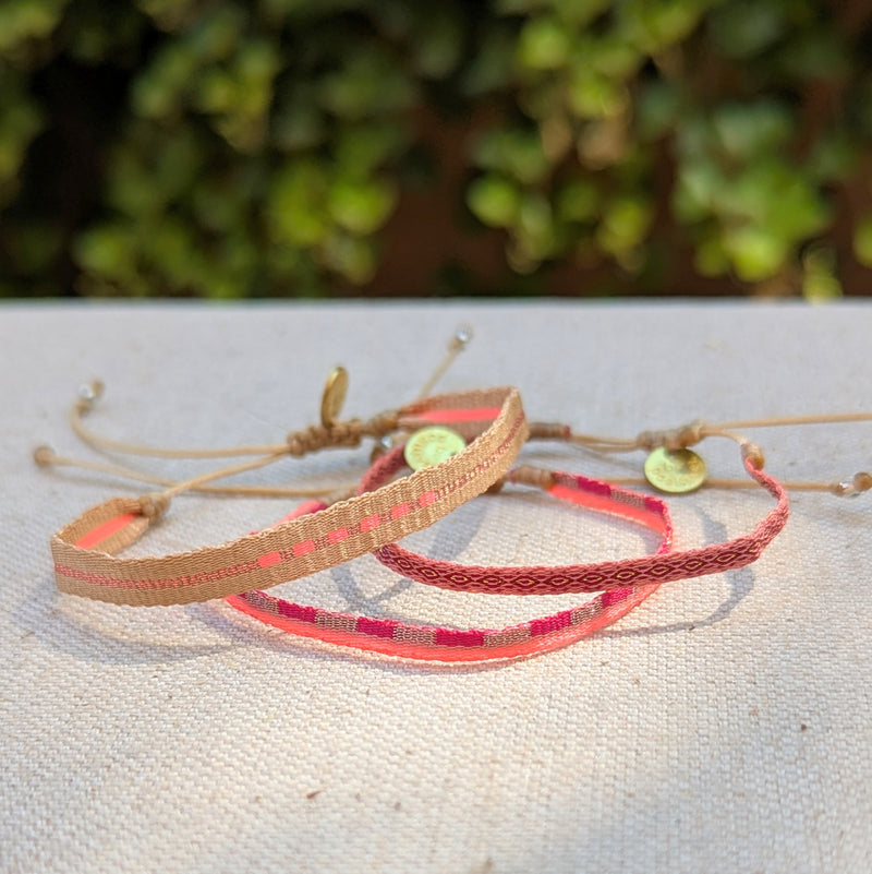 Three woven headbands with different color patterns on a textured surface with a blurred green background.

Guanabana woven bracelet handmade jewelry store sowa boston gift shop small business boutique small gifts for her unisex