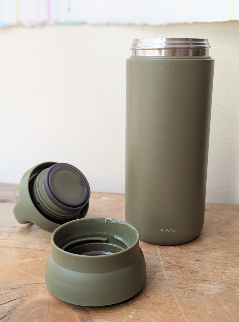 Green thermos bottle with open lid on a wooden surface

Japanese KINTO day off tumbler metal water bottle thermos insulated sowa Boston gift shop boutique store