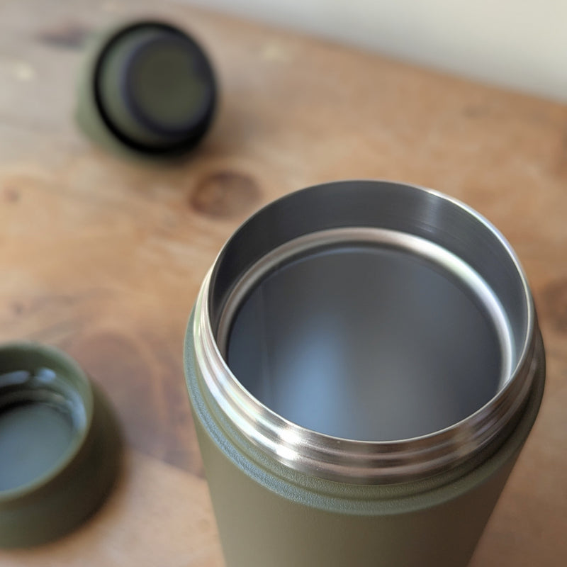 Green insulated bottle with silver interior on a wooden surface

Japanese KINTO day off tumbler metal water bottle thermos insulated sowa Boston gift shop boutique store