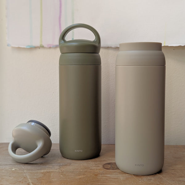Two insulated bottles, one green and one beige, on a wooden surface with a neutral background.

Japanese KINTO day off tumbler metal water bottle thermos insulated sowa Boston gift shop boutique store