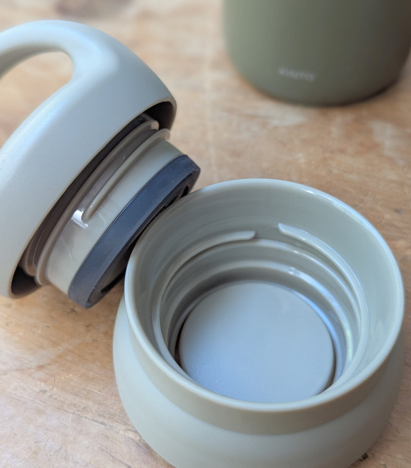 Light beige water bottle cap on a wooden surface

Japanese KINTO day off tumbler metal water bottle thermos insulated sowa Boston gift shop boutique store