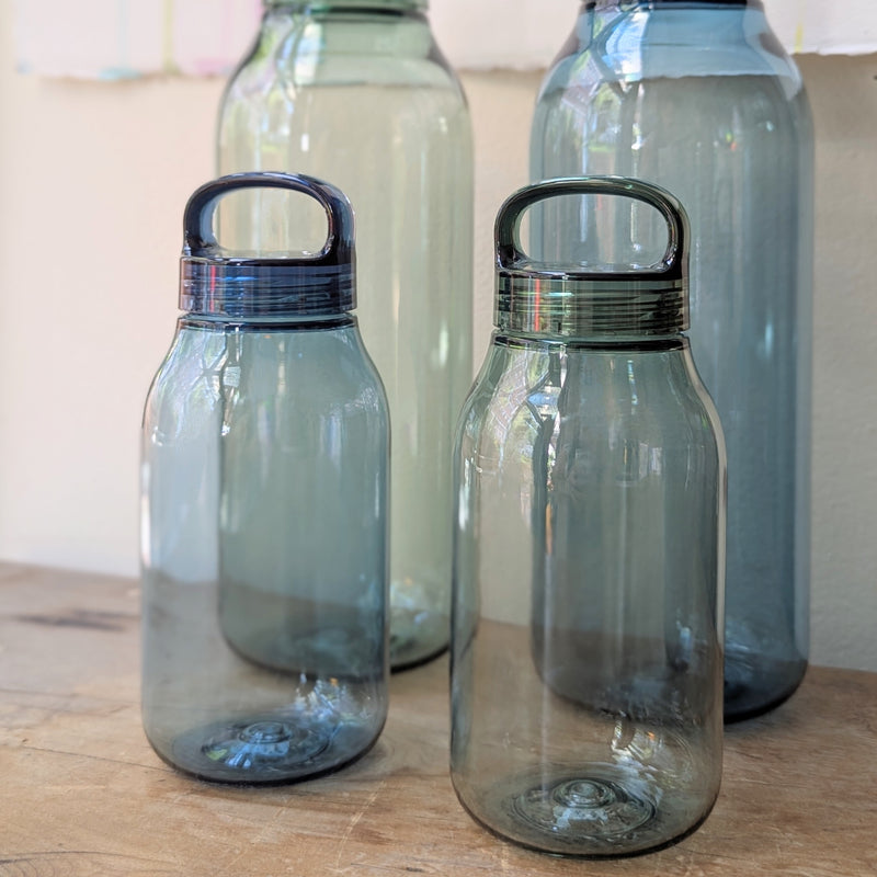 Set of four transparent water bottles with lids on a wooden surface.

Japanese water bottles plastic travel portable clear transparent BPA free KINTO sowa Boston gift shop boutique store