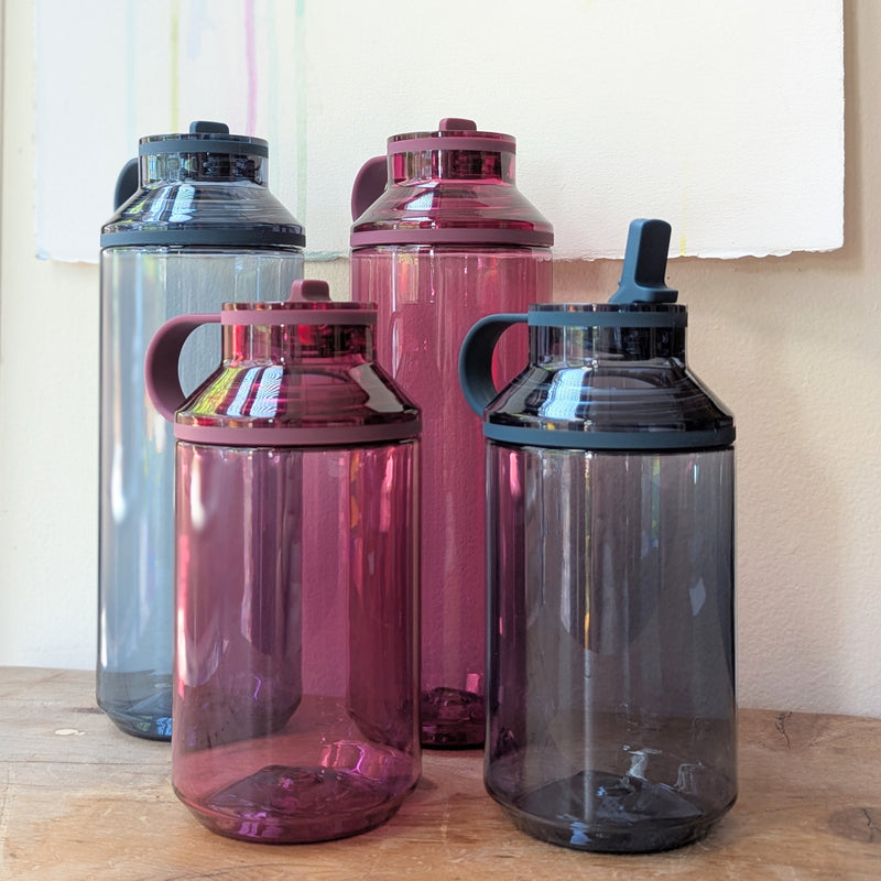 Set of four water bottles on a wooden surface.

Japanese water bottles plastic travel portable clear transparent BPA free KINTO sowa Boston gift shop boutique store