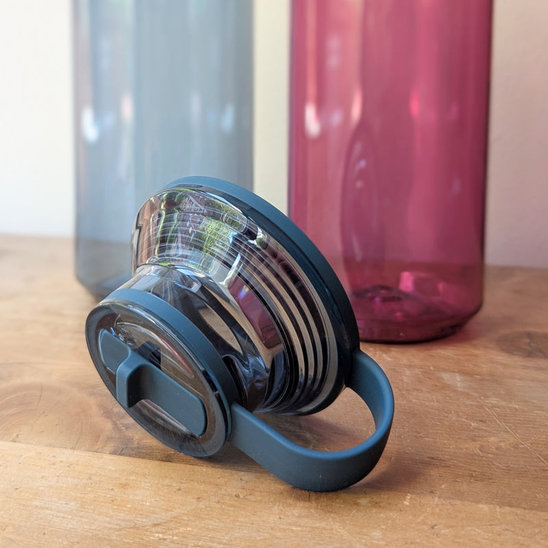 Blue water bottle cap with two bottles in the background on a wooden surface

Japanese reusable water bottles plastic travel portable clear transparent BPA free KINTO sowa Boston gift shop boutique store