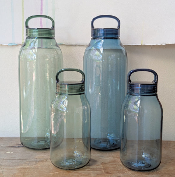 Four transparent water bottles on a wooden surface.

Japanese water bottles plastic travel portable clear transparent BPA free KINTO sowa Boston gift shop boutique store