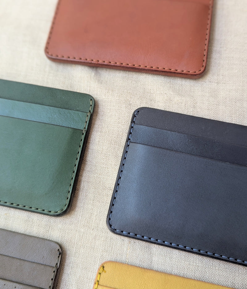 Collection of leather card holders in various colors on a textured surface

Wooly Made cardholder handmade leather small wallet sowa boston small business gift shop boutique gifts for him unisex