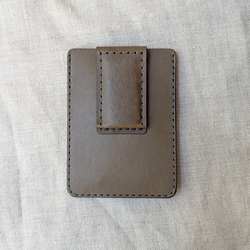 Olive brown eather money clip on a light gray fabric background

woolly made unisex men's cardholder money clip magnet leather wallet shop boston gift store sowa boutique