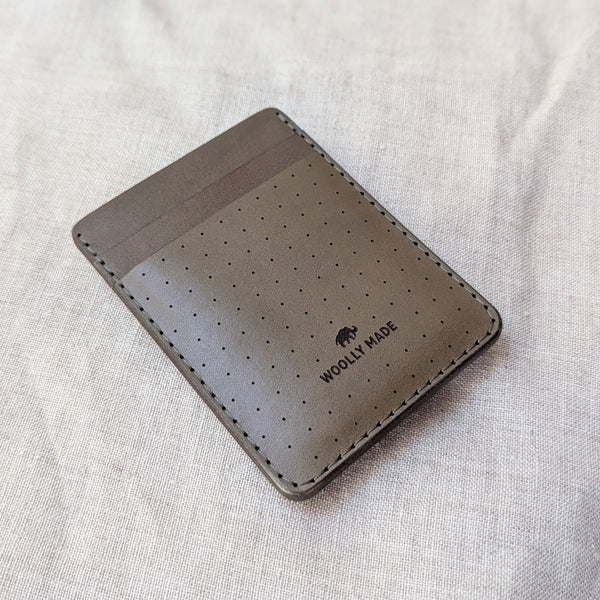 Olive brown perforated wallet with 'Woolly Made' branding on a light gray fabric background

woolly made unisex men's cardholder money clip magnet leather wallet shop boston gift store sowa boutique
