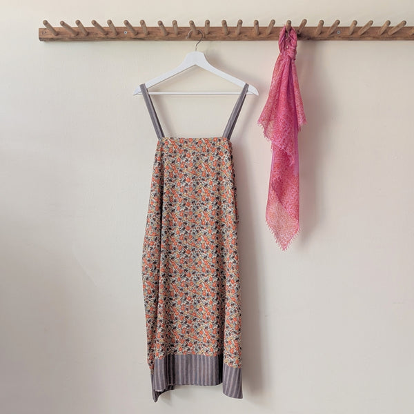 Nightgown with floral pattern and pink scarf on a hanger against a white wall.

Domi slip dress nightgown organic cotton pjs pajamas sleepwear loungewear shop boston sowa boutique store gift
                                                                                             