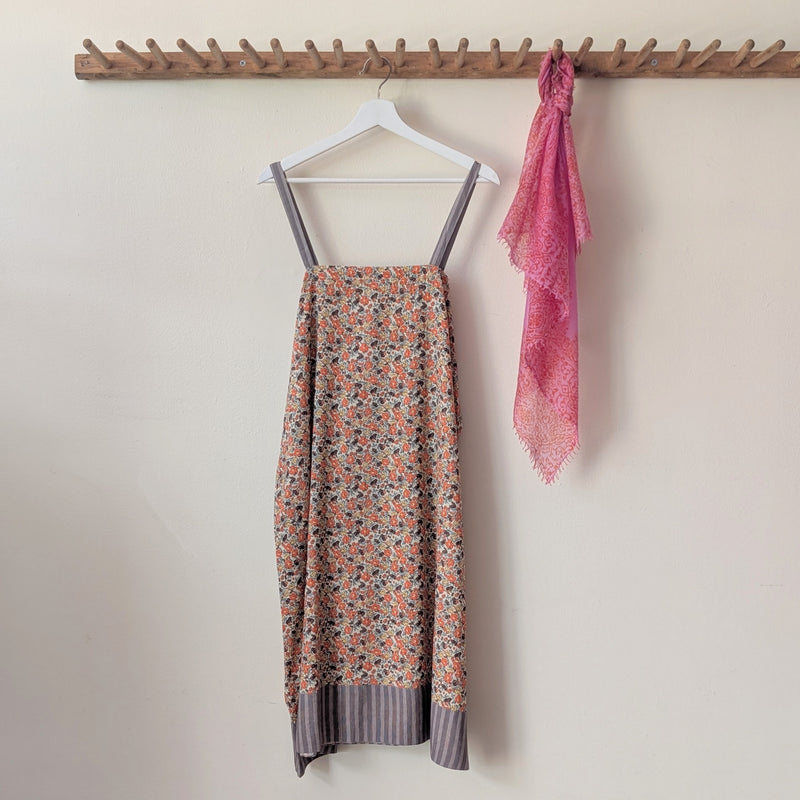 Nightgown with floral pattern and pink scarf on a hanger against a white wall.

Domi slip dress nightgown organic cotton pjs pajamas sleepwear loungewear shop boston sowa boutique store gift
                                                                                             