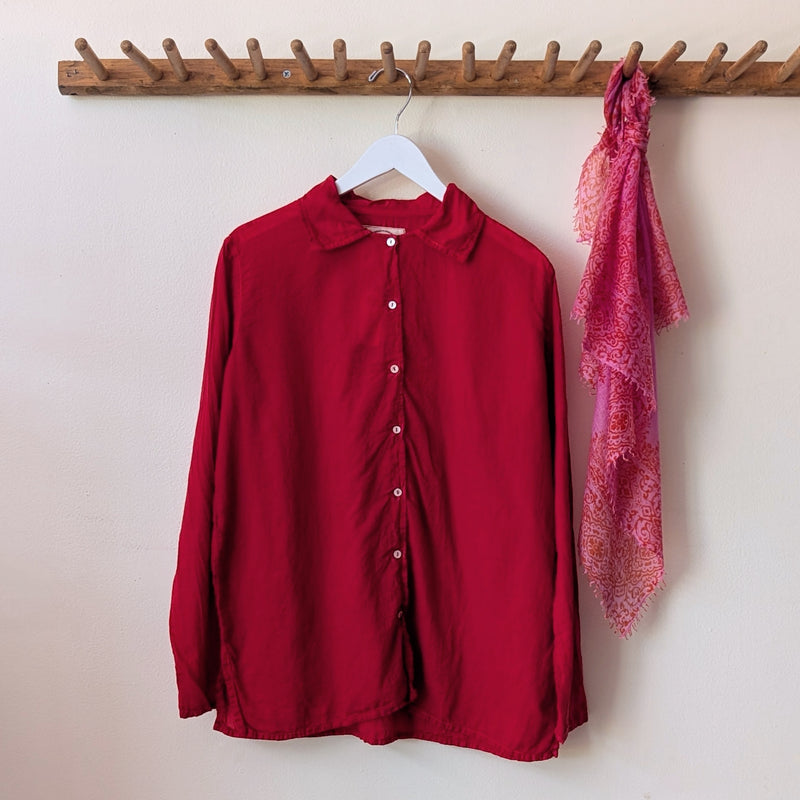 Red shirt and pink scarf hanging on a wooden rack against a white wall.

Auntie Oti button down khadi cotton lightweight shirt sowa boston small business gift shop boutique