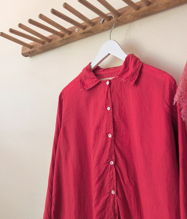 Red shirt on a hanger against a beige wall with a wooden rack above.

Auntie Oti button down khadi cotton lightweight shirt sowa boston small business gift shop boutique