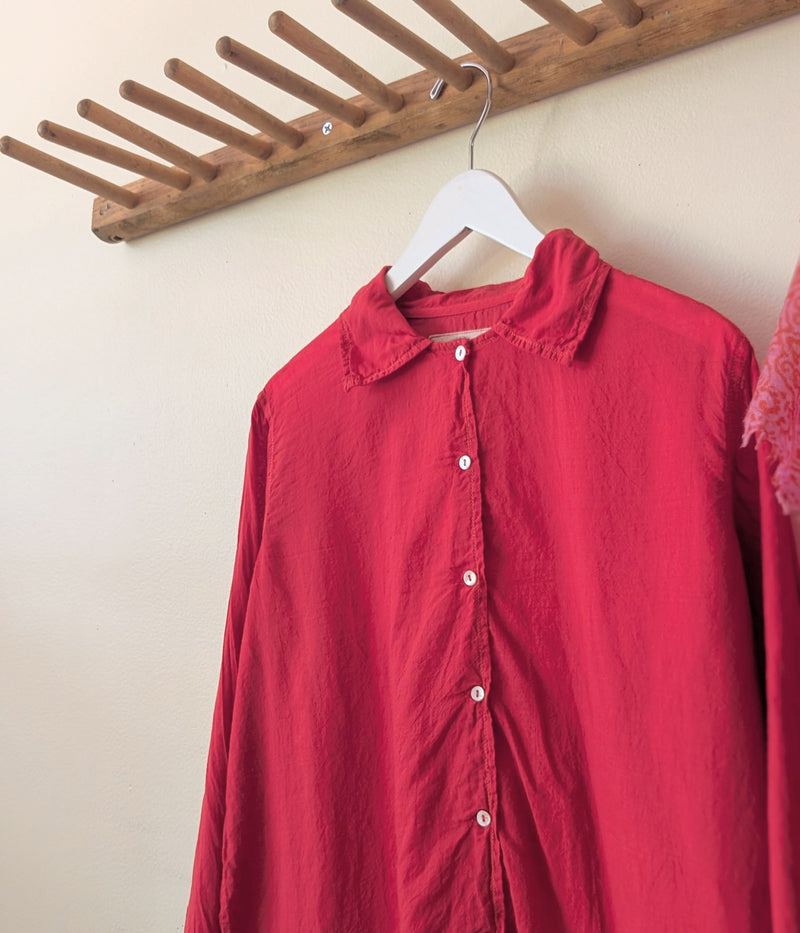 Red shirt on a hanger against a beige wall with a wooden rack above.

Auntie Oti button down khadi cotton lightweight shirt sowa boston small business gift shop boutique