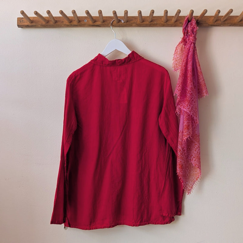 Red blouse and pink scarf hanging on a wooden rack against a beige wall.

Auntie Oti button down khadi cotton lightweight shirt sowa boston small business gift shop boutique
