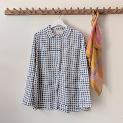 Blue patterned shirt and colorful scarf hanging on a wooden rack against a plain wall.

Auntie Oti button down cotton shirt polka dot block printed sowa boston small business gift shop boutique